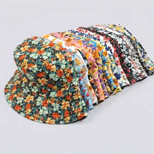 Multiple colorful floral print bucket hats stacked together in various bright summer patterns