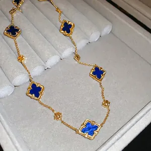 Elegant gold plated necklace featuring multiple deep blue clover motifs on a thin chain