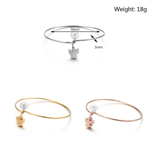Adjustable twisted wire bangle in gold silver and rose gold with wing charms and pearls