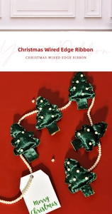 Close-up of dark green velvet Christmas tree ribbon with pearl accents on red background
