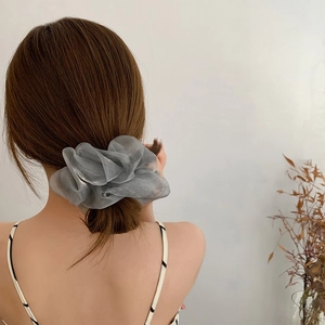 Detailed back view of a silver organza oversized scrunchie on a ponytail