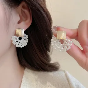 Elegant gold metal stud earrings with cluster pearls in a vintage floral design