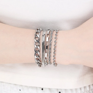 Close-up of 5-piece silver stackable bracelet set including Cuban and snake chains