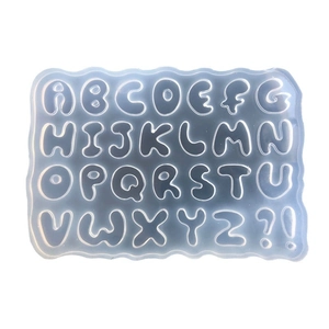 Transparent silicone mold for 26 English letters and punctuation marks on white background