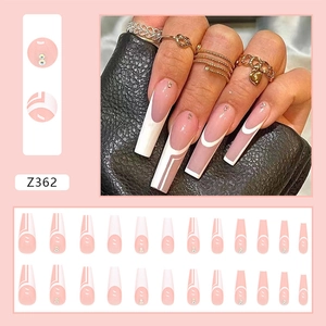 Detailed view of pink French coffin press-on nails with white geometric lines and rhinestones
