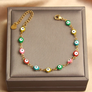 Detail of adjustable stainless steel evil eye bracelet with colorful enamel beads and lobster clasp