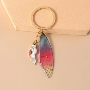 Detail of luxury bird and colorful gradient transparent insect wing keychain charm