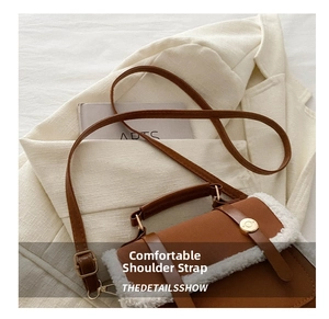 Close-up of retro brown PU bag showing soft faux fur trim and gold round metal buckle