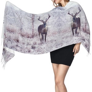 Winter pashmina shawl with reindeer pattern and fringe edges on female model