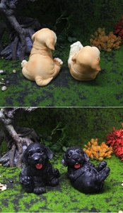 Textura detallada de resina de figuritas de cachorros labrador sentados y rodando