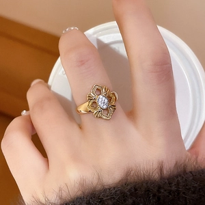 Detail of 24K gold plated flower ring with sparkling crystals on a hand