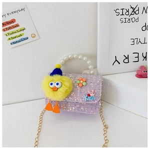 Detail of purple sequin kids bag with pearl handle, gold chain and plush duck toy