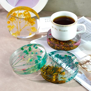 Handmade clear round resin coasters with dried flowers and tiger eye stones for home decor