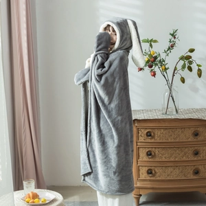 Detail view of the plush rabbit ear hood on a dark gray fleece wearable blanket