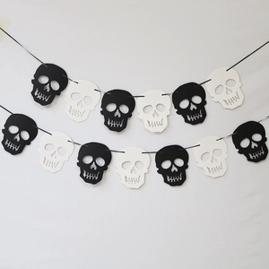 Detail view of black and white skull banner for Halloween party paper decorations