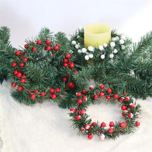 Detail of Christmas candle ring with pine needles and red white berries on white fur