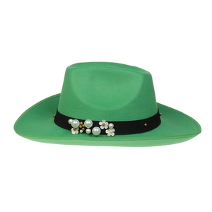 Detailed view of green wool felt cowboy hat featuring floral ribbon and pearl accents