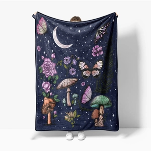 Detailed view of large flannel blanket with vintage mushroom and floral prints