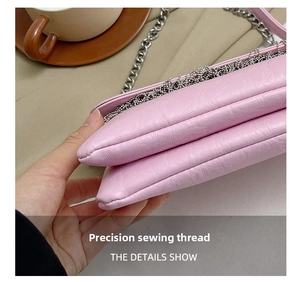 Detail showing the precision stitching and fine leather texture of the pink crossbody bag