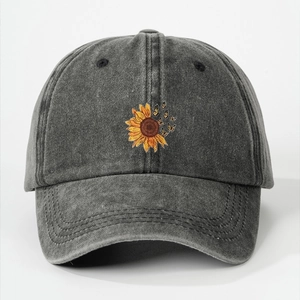 Detail of sunflower and butterfly embroidery on a vintage washed grey baseball cap
