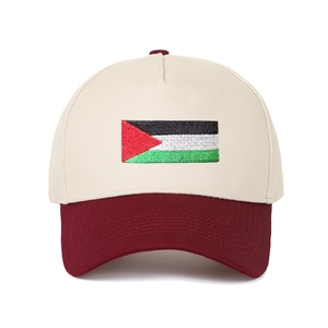 Close-up of the Palestine flag embroidery on a two-tone beige and maroon baseball cap