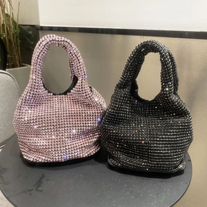 Sparkling rhinestone bucket bag in pink and black featuring elegant metal chain straps