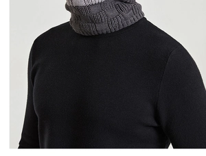 Detail showing the thick knit texture of the black beanie and gray neck warmer set