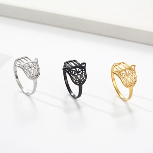 Detailed trio of Hamsa Hand rings in silver, black, and gold metal with hollow patterns