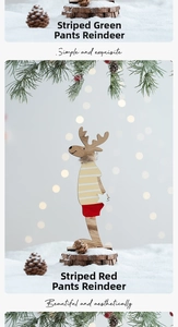 Detail of wooden Christmas reindeer figurines with striped outfits on rustic bases