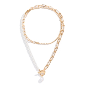 Gold layered necklace with faux pearls and OT buckle clasp on white background