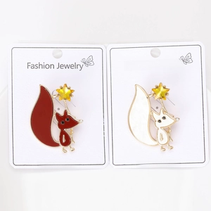 Detail of fox brooches with enamel finish and yellow stars on white jewelry cards