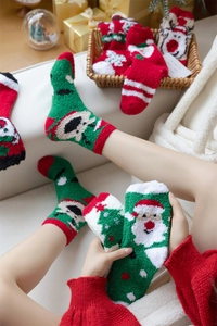 Close-up of thick coral fleece Christmas socks featuring Santa Claus and Elf patterns