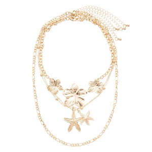 Gold multi-layered necklace set featuring metallic flower and starfish pendants for women