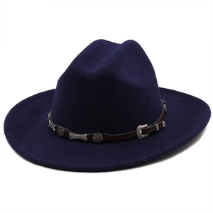 Detail of dark blue felt cowboy hat featuring leather band and silver star accents