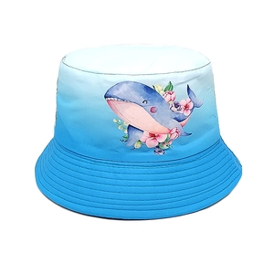 Detail of child's bucket hat showing gradient blue fabric and watercolor whale print