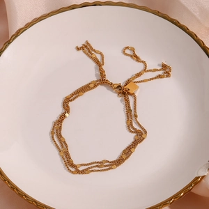 Detail of 18K gold plated multi-layer chain bracelet with sequins and lobster clasp