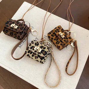 Set of three leopard print mini pouches with gold twist locks and detachable shoulder straps