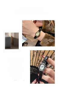 Macro detail of oval diamond bezel watch with Roman numerals and black leather strap