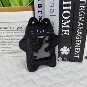 Detail view of a black plush cat photo card holder with a transparent window and soft texture
