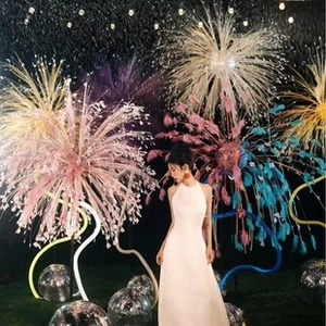Artistic outdoor shot of a white halter neck long maxi dress on a model in scenic setting