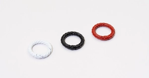 Detailed shot of twist texture round spring snap hooks in white, black and red colors