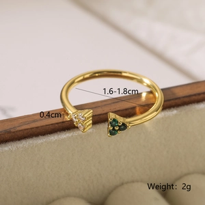 Macro shot showing dimensions of a gold geometric open ring with green gems and zircons