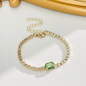 Golden Cuban link bracelet with square emerald green gemstone and champagne accents