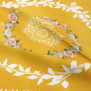 Close-up of yellow cotton linen fabric with floral rose and leaf wreath printing