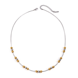 Close-up of dual-tone gold and silver metal beads on a stainless steel snake chain