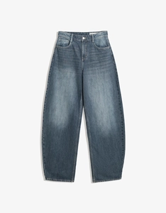 Detail of high waisted wide leg jeans with vintage wash and distressed denim texture