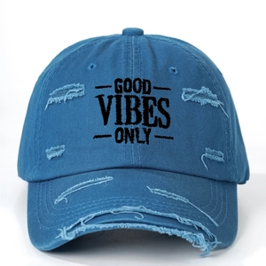 Detail of distressed navy blue baseball cap with GOOD VIBES ONLY embroidery and torn effects