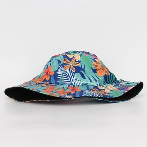 Side view of a bucket hat featuring a vibrant tropical floral and leaf pattern