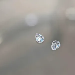 Pair of pear-shaped clear zircon nail crystals with faceted cut for nail art designs