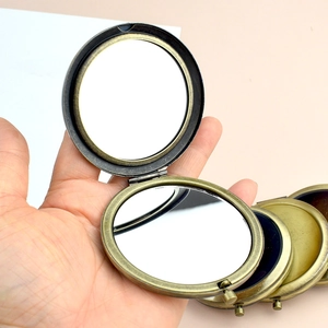 Vintage bronze folding double-sided metal makeup mirror with a portable round design